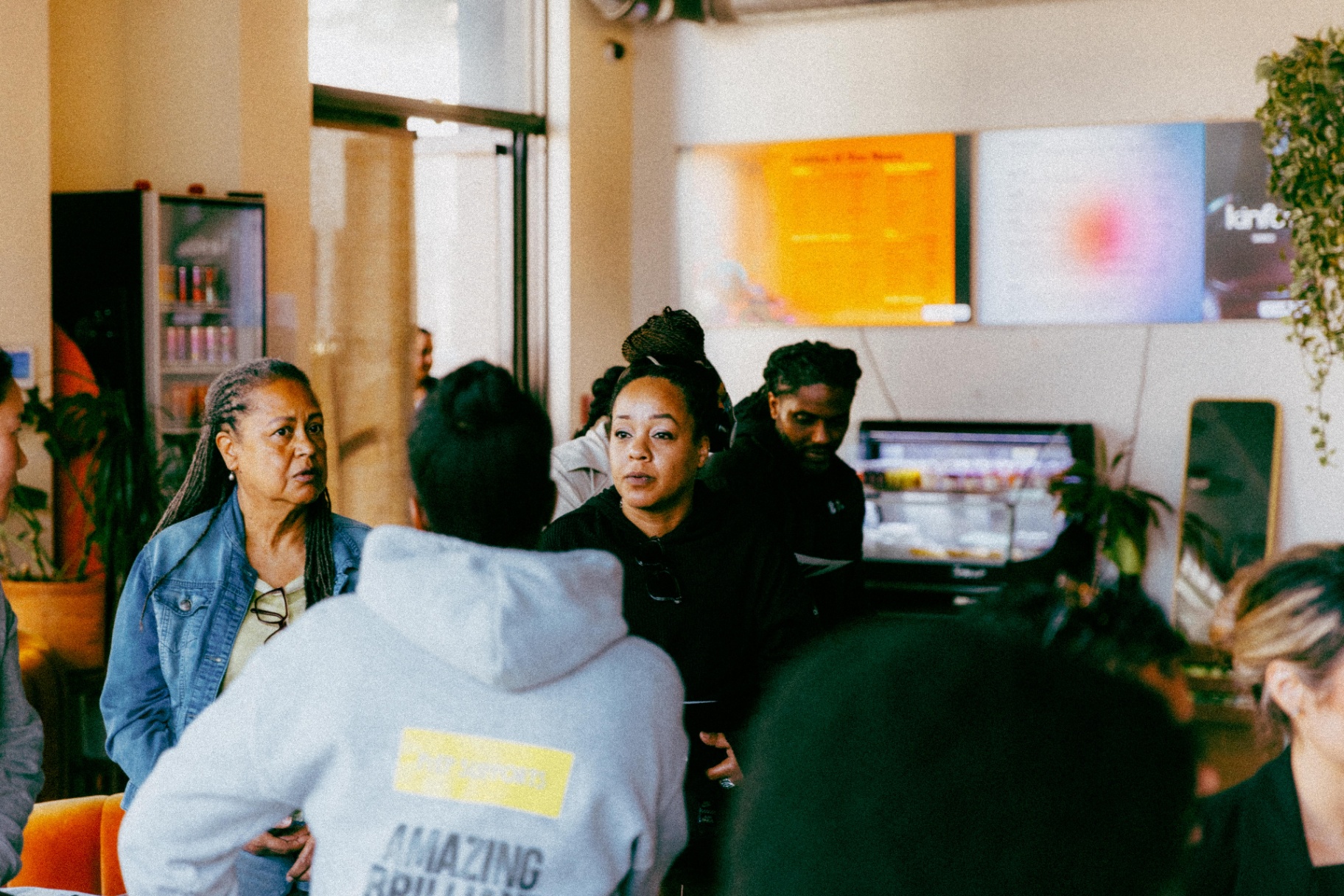 Community members in conversation at a café gathering.