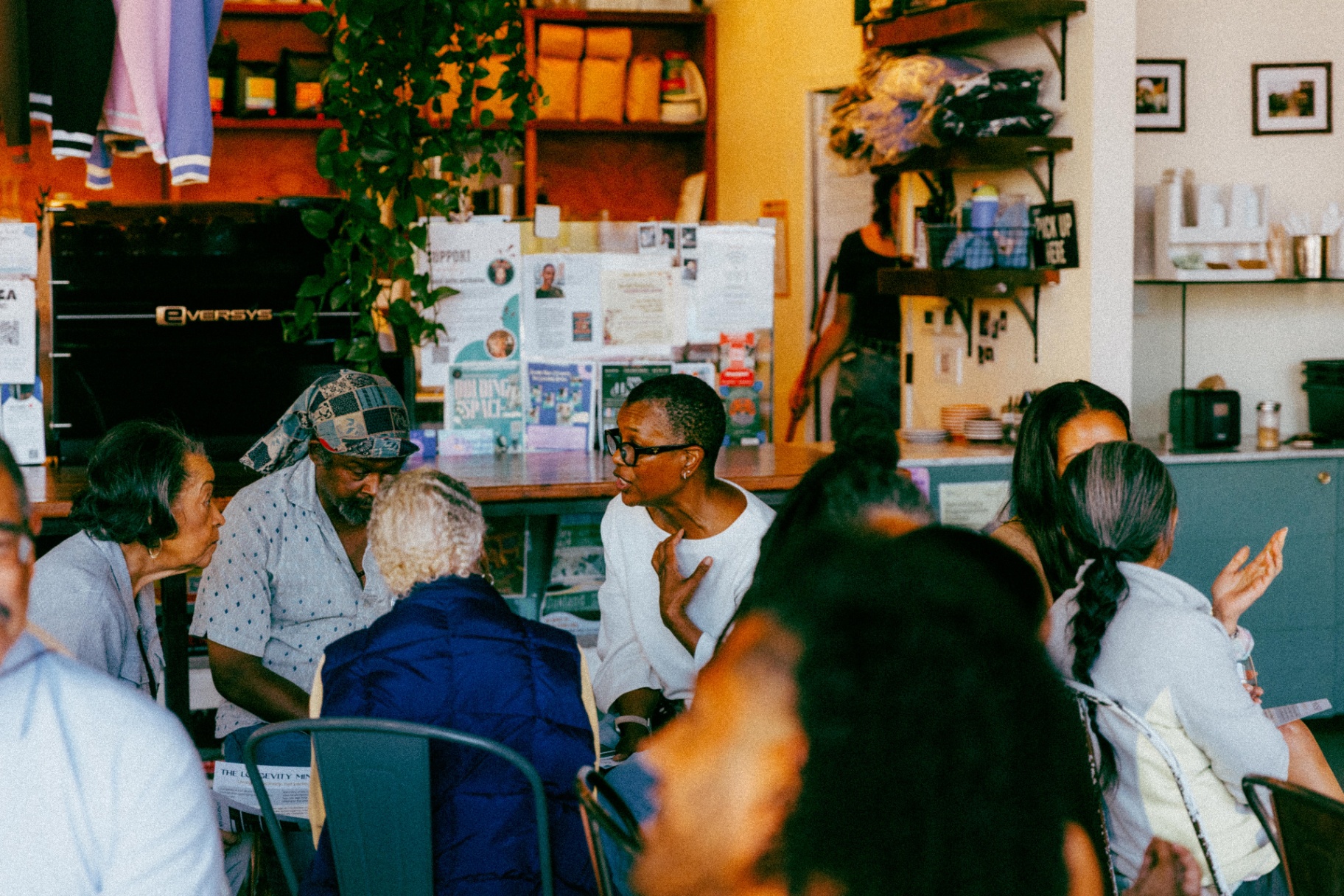 Neighbors in conversation around a table at a Longevity for the People gathering.